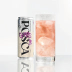 Grape juice can and glass with pink liquid on a white background